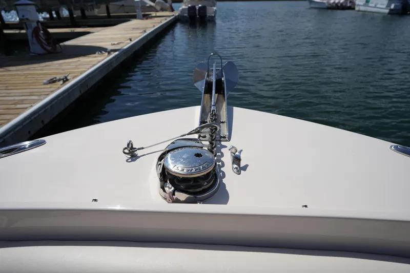 Slide: The Image of Bow of 2021 Grady-White Freedom 235 boat at dock, featuring anchor and winch. - 37