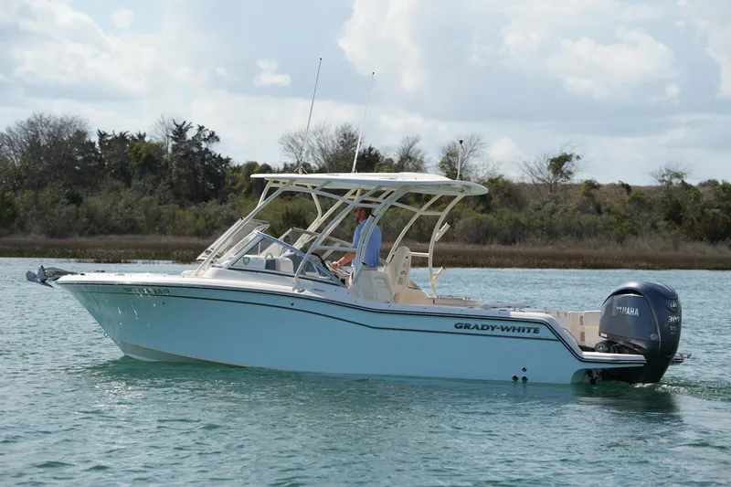 Slide: The Image of 2021 Grady-White Freedom 235 boat cruising on calm water. - 5