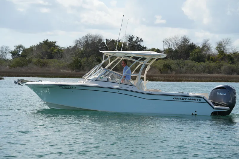 Slide: The Image of 2021 Grady-White Freedom 235 boat cruising on calm water with Yamaha engine. - 6