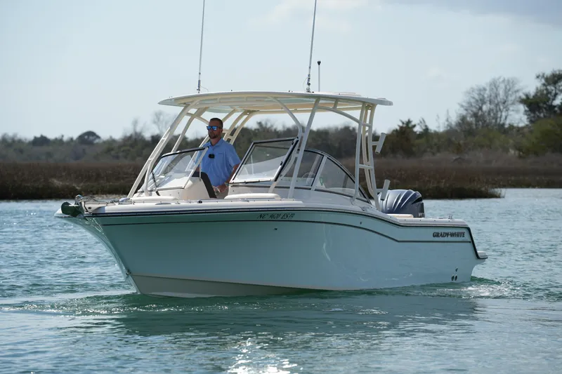 Slide: The Image of 2021 Grady-White Freedom 235 boat cruising on calm water. - 8