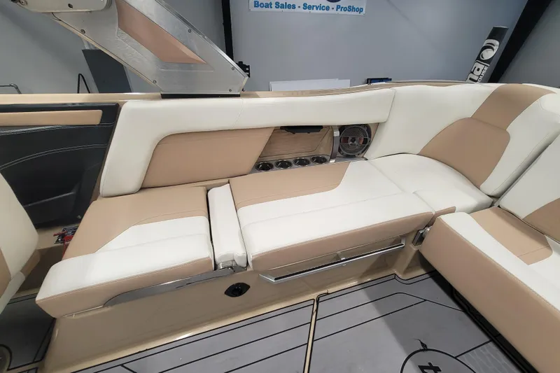 Slide: The Image of 2022 MasterCraft X24 interior with beige and white seating, showcasing luxury boat design. - 11