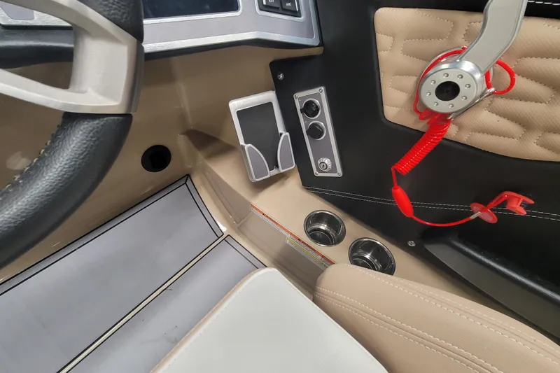 Slide: The Image of Interior of a 2022 MasterCraft X24 boat, featuring steering wheel and control panel. - 17