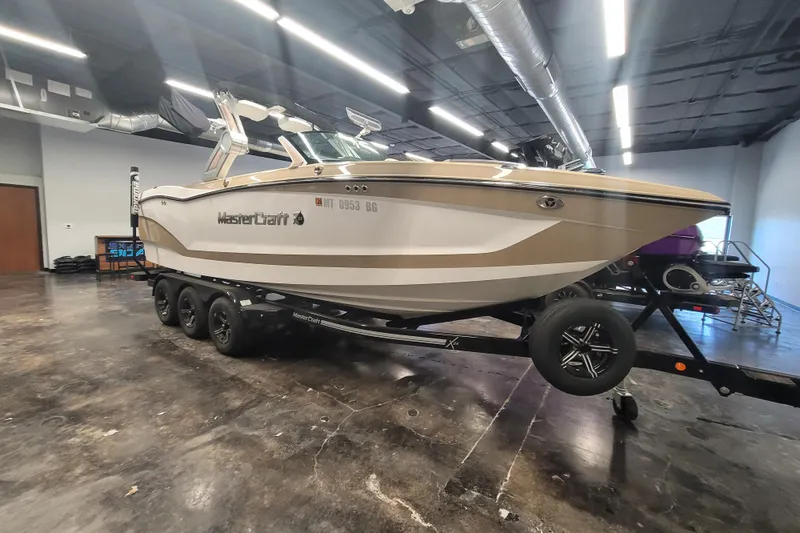 Slide: The Image of 2022 MasterCraft X24 boat on trailer in indoor showroom setting. - 3