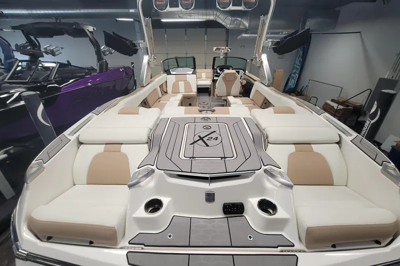 Slide: The Image of 2022 MasterCraft X24 boat interior with luxurious seating and modern design. - 6