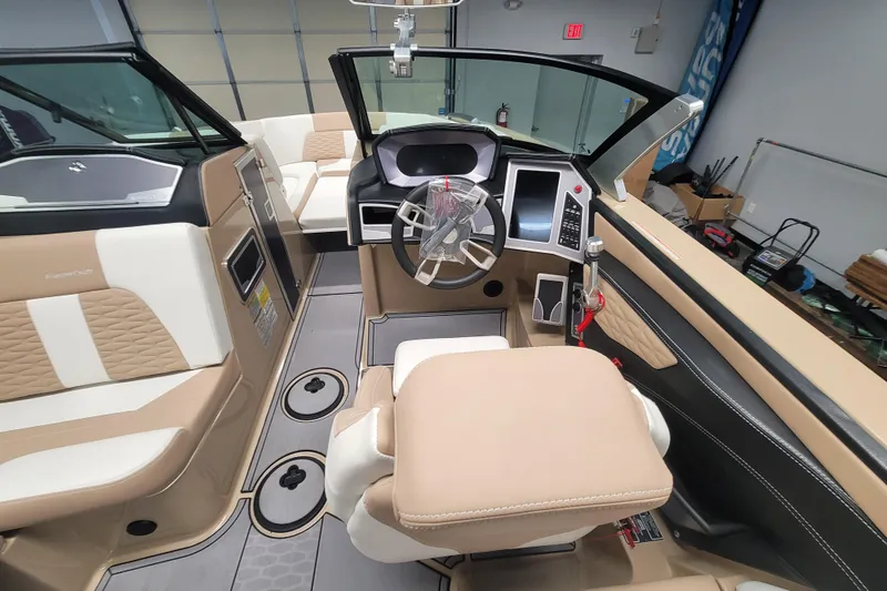 Slide: The Image of 2022 MasterCraft X24 boat interior with modern dashboard and luxurious seating. - 8