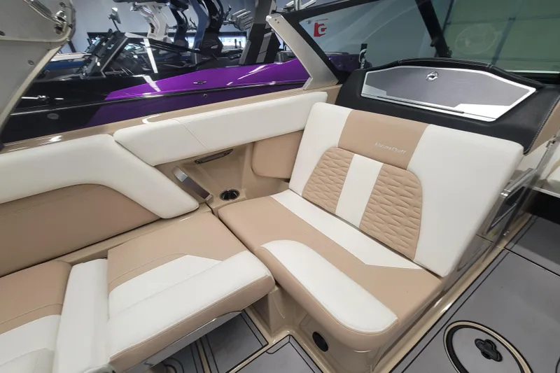 Slide: The Image of 2022 MasterCraft X24 boat interior with beige and white seating, showcasing luxury design. - 9