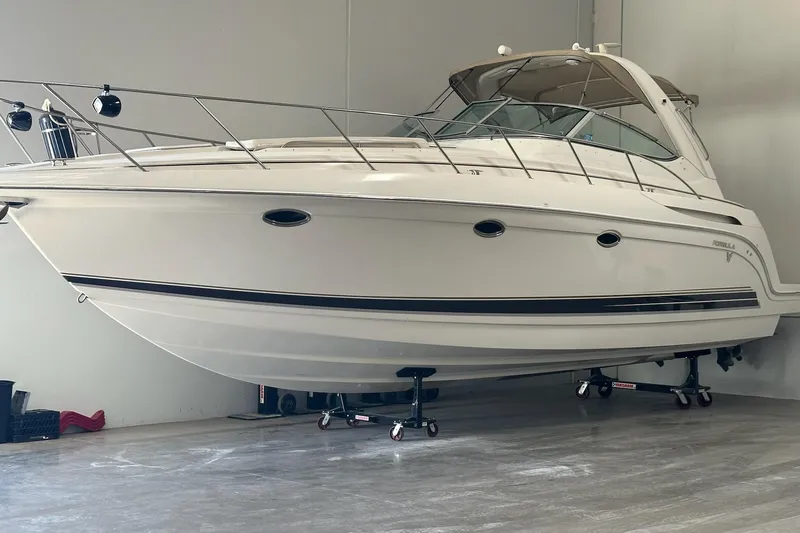 The Image of 2002 Formula 37 Performance Cruiser in storage, showcasing sleek design and white exterior. - 1