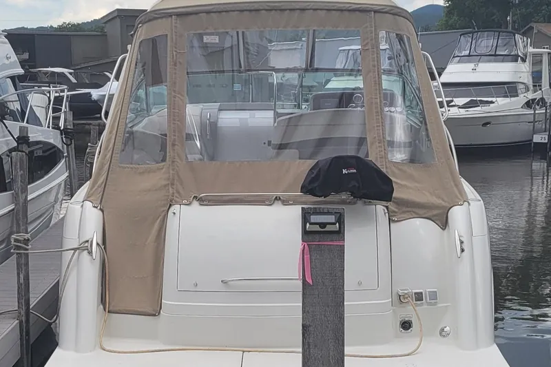 Slide: The Image of 2002 Formula 37 Performance Cruiser docked at marina, rear view with tan canopy. - 5