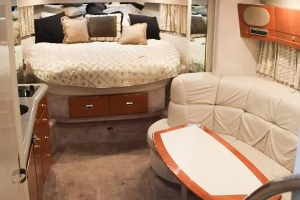 Slide: The Image of 2002 Formula 37 Performance Cruiser interior with bed, seating, and table in cozy cabin. - 9