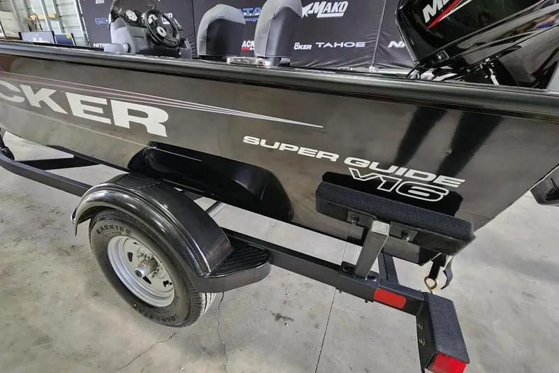 Slide: The Image of 2026 Tracker Super Guide V-16 SC boat on trailer in showroom. - 11