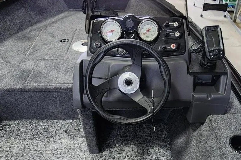 Slide: The Image of 2026 Tracker Super Guide V-16 SC boat dashboard with steering wheel and gauges. - 4