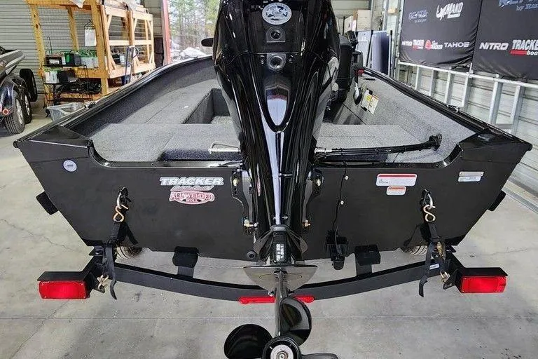 Slide: The Image of 2026 Tracker Super Guide V-16 SC boat, rear view in a showroom setting. - 5