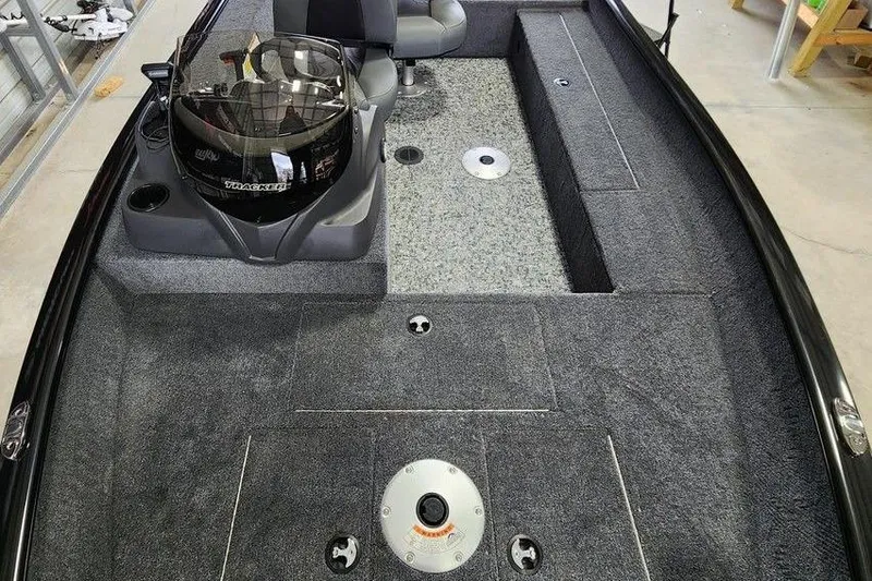 Slide: The Image of 2026 Tracker Super Guide V-16 SC boat interior with seating and carpeted deck. - 6