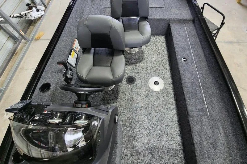 Slide: The Image of 2026 Tracker Super Guide V-16 SC boat interior with dual seats and steering console. - 8