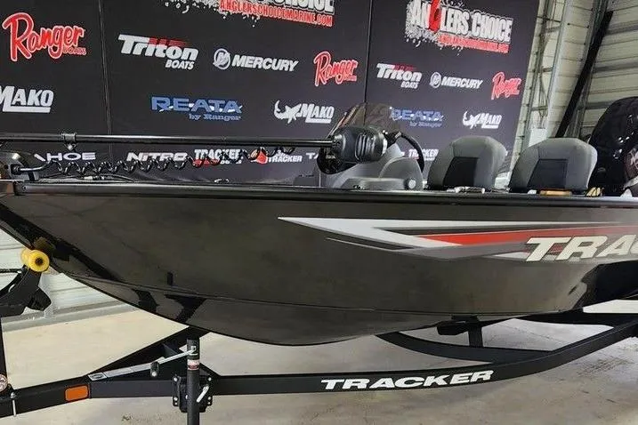 Slide: The Image of 2026 Tracker Super Guide V-16 SC boat on display in showroom with branded backdrop. - 9