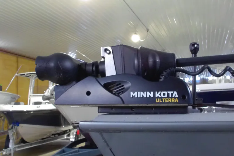 Slide: The Image of 2024 Smoker Craft Phantom 20 X2 with Minn Kota Ulterra motor in a showroom. - 2