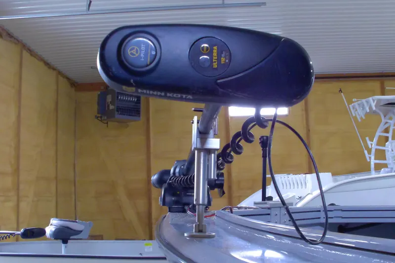 Slide: The Image of 2024 Smoker Craft Phantom 20 X2 with Minn Kota trolling motor in a garage. - 3