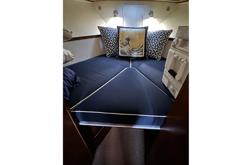 Slide: The Image of 1968 Chris-Craft 35 Commander cabin interior with stylish bedding and decorative pillows. - 11