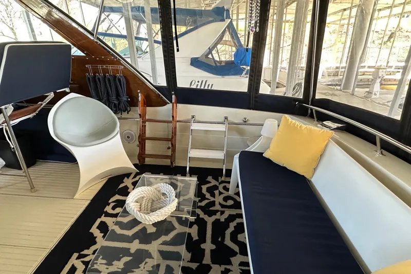 Slide: The Image of 1968 Chris-Craft 35 Commander interior with modern seating, nautical decor, and large windows. - 15
