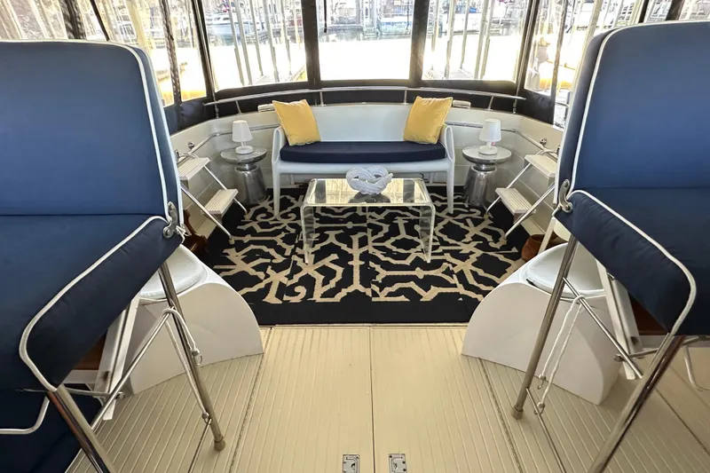 Slide: The Image of 1968 Chris-Craft 35 Commander interior with blue seating, patterned rug, and glass table. - 16