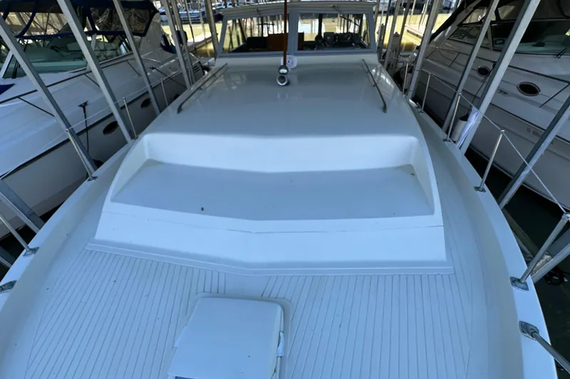 Slide: The Image of 1968 Chris-Craft 35 Commander boat deck, white finish, docked among other vessels. - 18