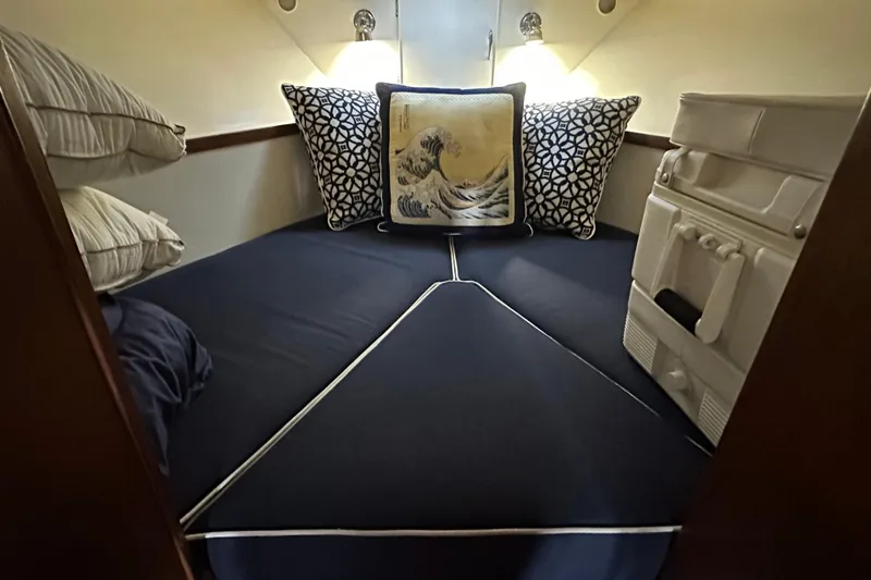 Slide: The Image of Cozy cabin interior of 1968 Chris-Craft 35 Commander with nautical-themed pillows and bedding. - 4