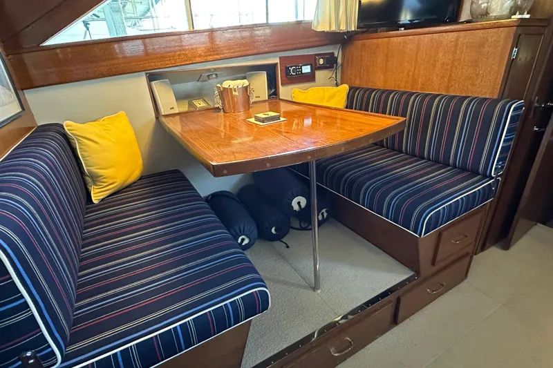 Slide: The Image of Interior of 1968 Chris-Craft 35 Commander with striped seating and wooden table. - 7