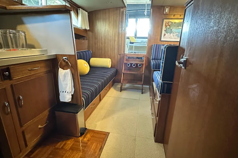 Slide: The Image of 1968 Chris-Craft 35 Commander interior with wood cabinetry and striped seating. - 8
