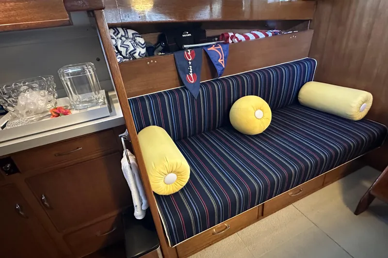 Slide: The Image of 1968 Chris-Craft 35 Commander interior with striped seating and yellow cushions. - 9