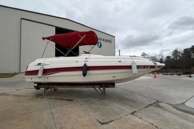 The Image of Chaparral 232 Sunesta 2000 boat with red canopy at marina dock. - 1