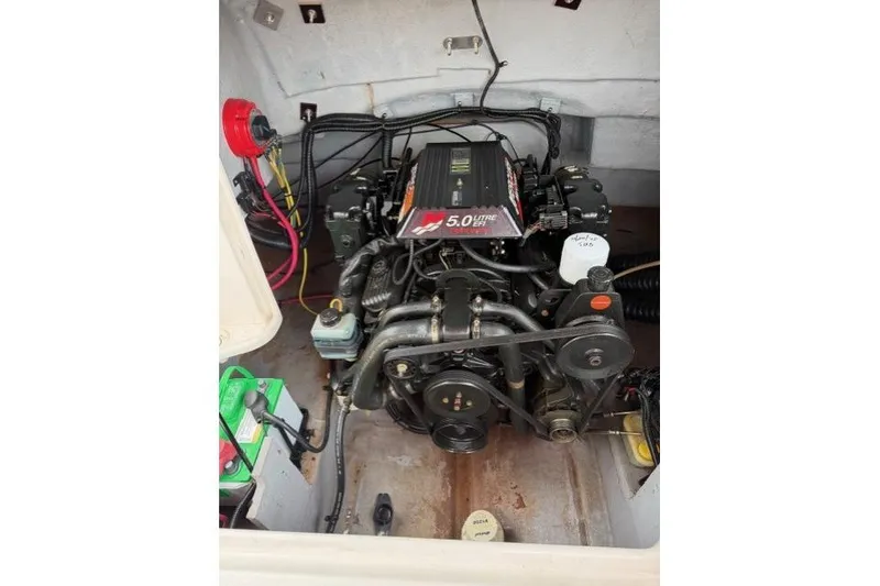 Slide: The Image of Engine compartment of a 2000 Chaparral 232 Sunesta boat, featuring a 5.0L engine. - 10
