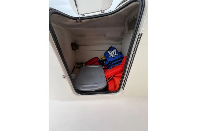 Slide: The Image of Storage compartment of 2000 Chaparral 232 Sunesta boat with life jackets and gear. - 14