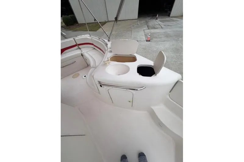 Slide: The Image of 2000 Chaparral 232 Sunesta boat interior with seating and storage compartments. - 9