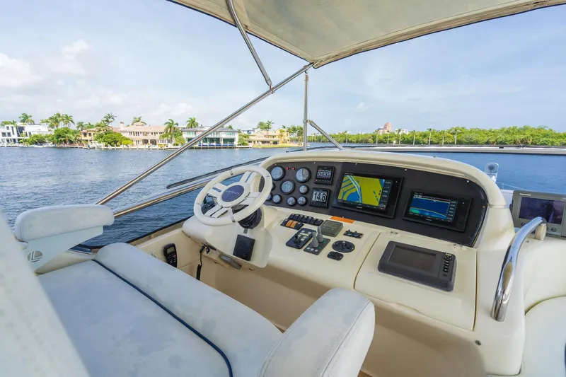 Slide: The Image of Azimut 62E yacht helm, 2009 model, overlooking serene waters. - 13