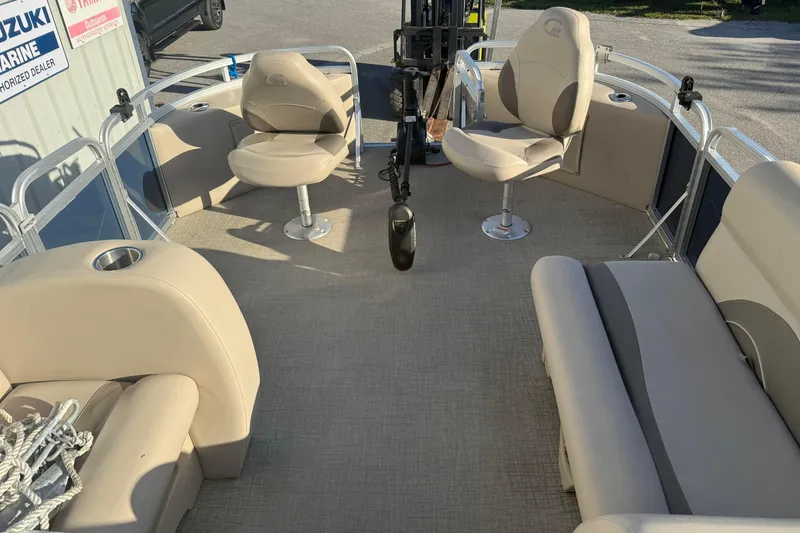 Slide: The Image of 2021 Avalon 2480 GF pontoon boat interior with beige seating and cup holders. - 11