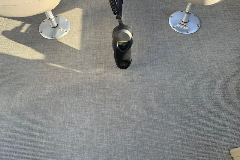 Slide: The Image of 2021 Avalon 2480 GF boat interior with textured flooring and mounted seats. - 12