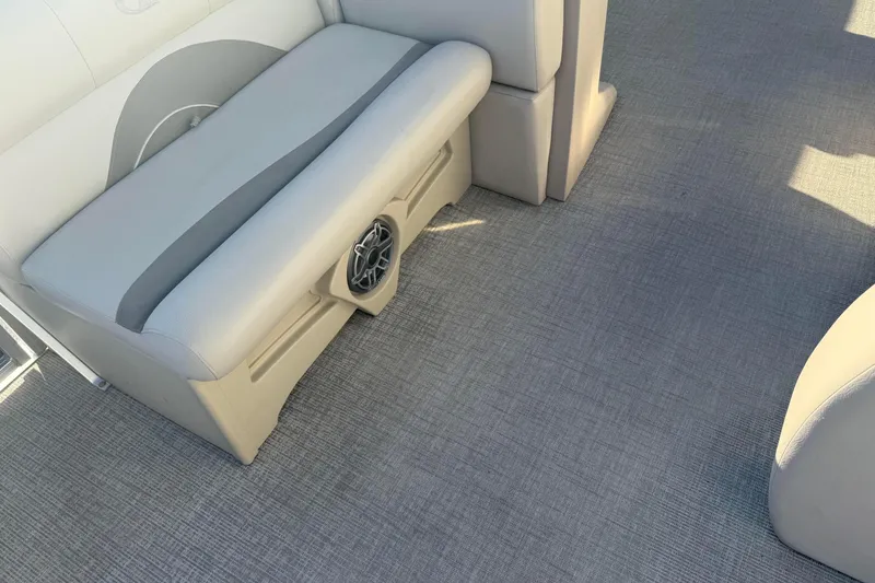Slide: The Image of 2021 Avalon 2480 GF boat interior with gray seating and integrated speaker. - 13