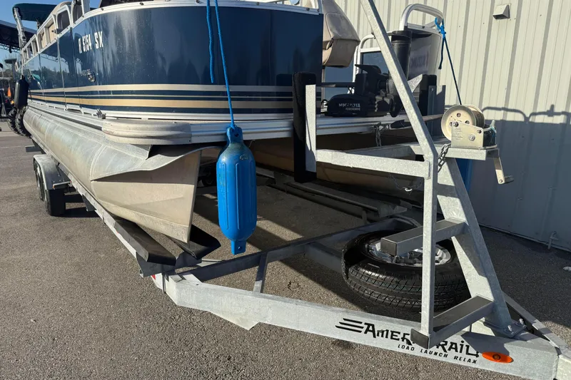 Slide: The Image of 2021 Avalon 2480 GF pontoon boat on trailer, parked outdoors. - 15