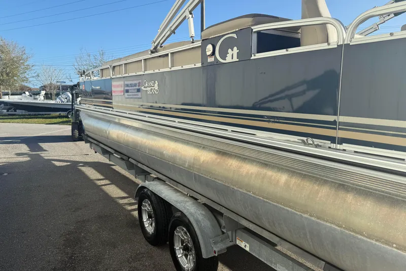 Slide: The Image of 2021 Avalon 2480 GF pontoon boat on trailer, side view in outdoor setting. - 5