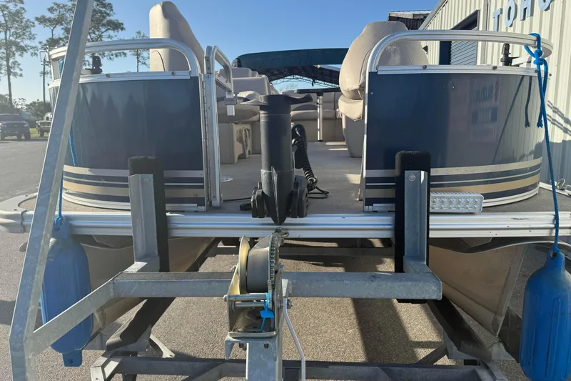 Slide: The Image of 2021 Avalon 2480 GF pontoon boat on trailer, rear view, sunny day. - 6