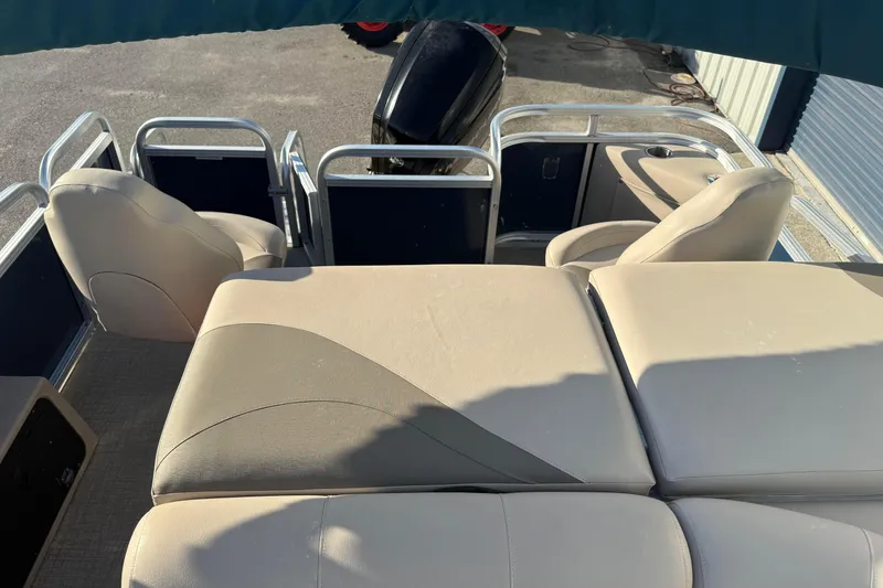 Slide: The Image of 2021 Avalon 2480 GF boat interior with beige seating and metal railings. - 7