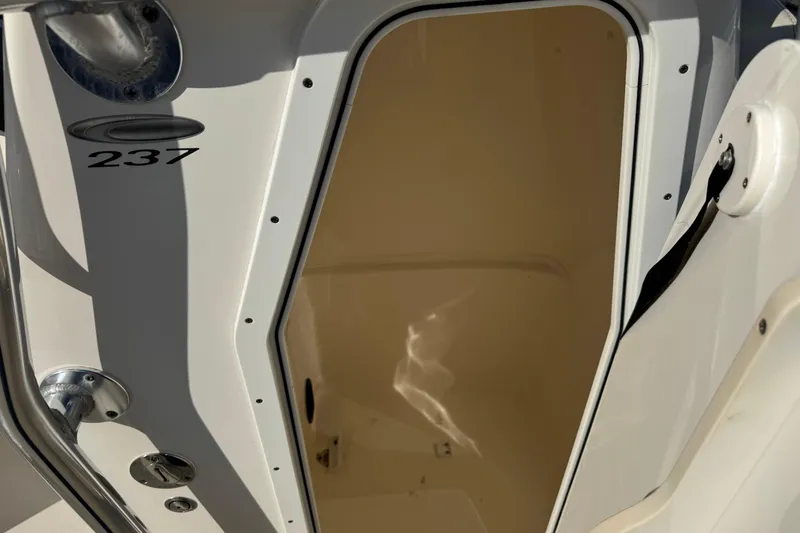 Slide: The Image of 2024 Cobia 237 Center Console boat interior view with open hatch. - 10