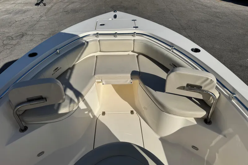 Slide: The Image of 2024 Cobia 237 Center Console boat interior with cushioned seating and storage. - 5
