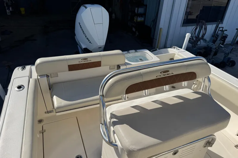 Slide: The Image of 2024 Cobia 237 Center Console boat interior with seating and Mercury engine. - 7