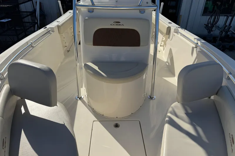 Slide: The Image of 2024 Cobia 237 Center Console boat interior with seating and console details. - 9