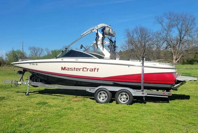 Slide: The Image of 2008 MasterCraft MariStar 245 boat on trailer outdoors. - 3