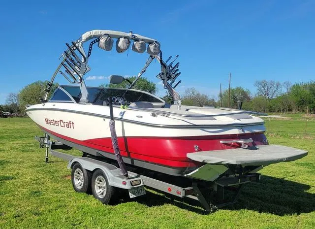 Slide: The Image of 2008 MasterCraft MariStar 245 boat on trailer outdoors. - 4