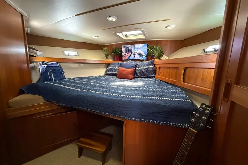 Slide: The Image of Interior of 1993 Riviera 47 Open Flybridge featuring cozy bedroom. - 17