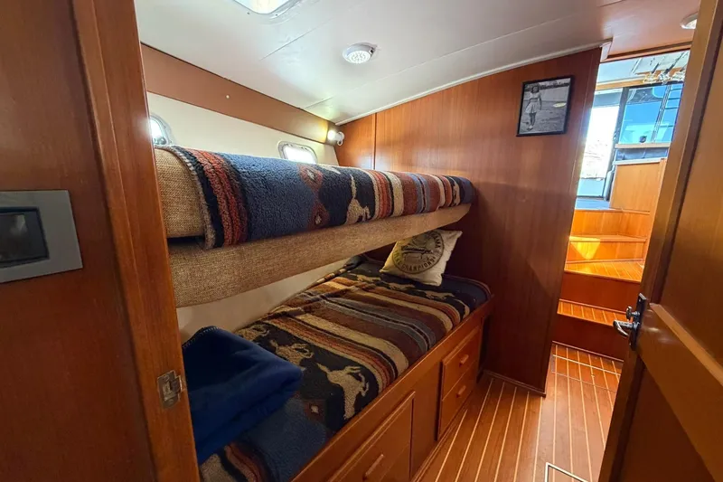 Slide: The Image of Cozy cabin interior of 1993 Riviera 47 Open Flybridge with bunk beds and decorative pillows. - 20