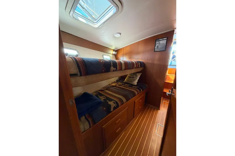 Slide: The Image of Cozy cabin with bunk beds in 1993 Riviera 47 Open Flybridge yacht. - 21